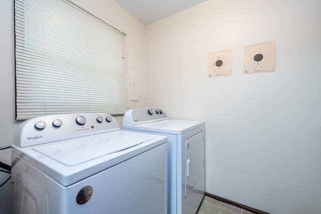 laundry area featuring laundry area, washer and clothes dryer, baseboards, and light tile patterned floors