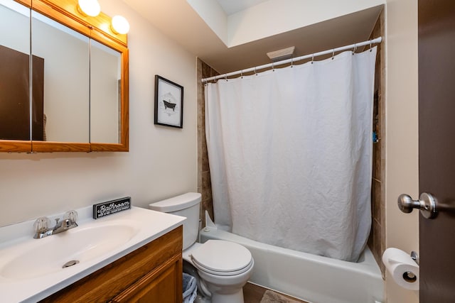 full bathroom with vanity, shower / bath combo with shower curtain, and toilet