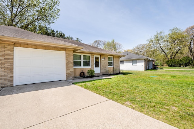 ranch-style home featuring brick siding, driveway, a front yard, and a garage