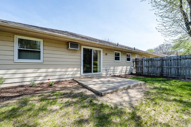 back of property with a patio, fence, and a yard