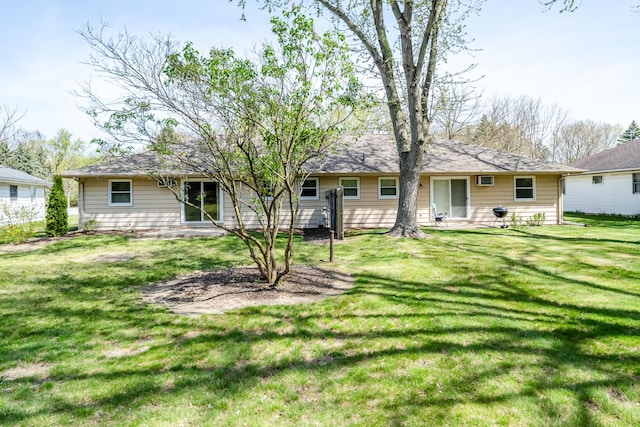 back of property featuring a lawn