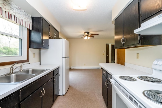 kitchen featuring a ceiling fan, white appliances, a baseboard radiator, under cabinet range hood, and a sink