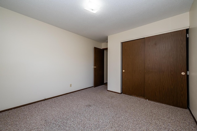 unfurnished bedroom featuring a closet, baseboards, and light carpet