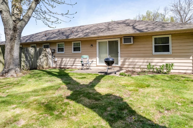 rear view of property with a yard and a patio area