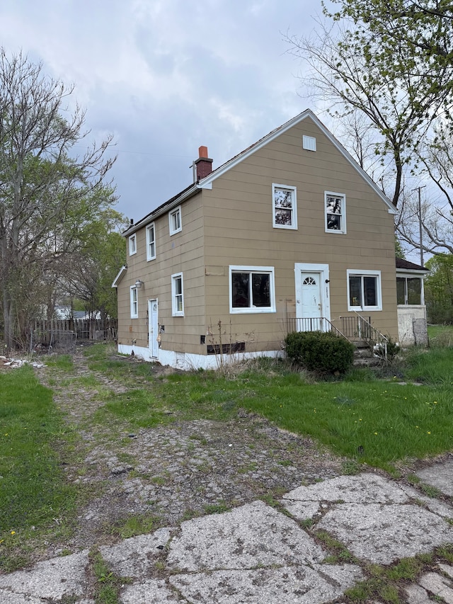 back of property featuring a chimney