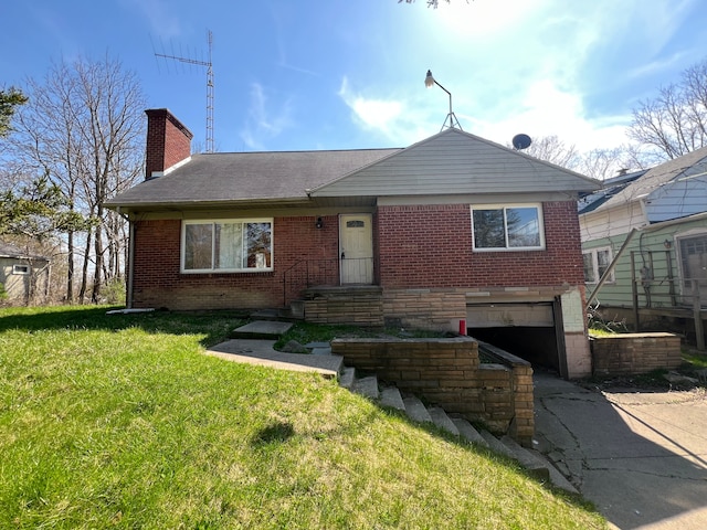 view of front of home featuring brick siding, a garage, a front lawn, and a chimney