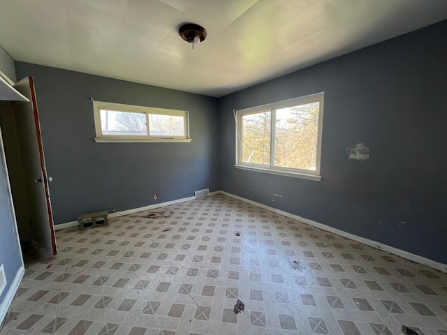 unfurnished bedroom featuring baseboards and visible vents