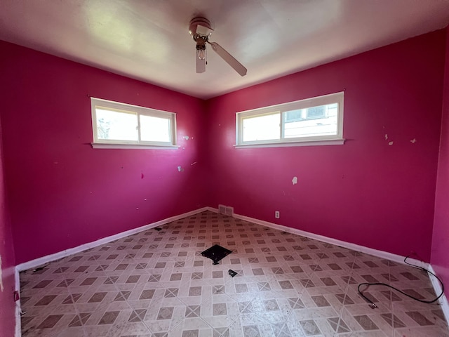 unfurnished room featuring visible vents, baseboards, and ceiling fan