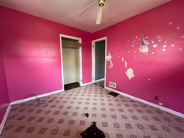 unfurnished bedroom with baseboards, ceiling fan, and visible vents