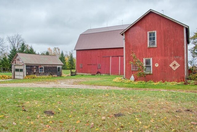 8390 E Pittsburg Rd, Durand, MI 48429 - view of barn featuring a yard