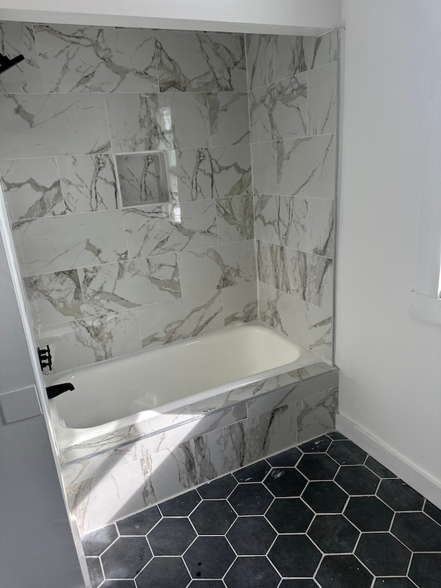 bathroom featuring tile patterned flooring and a combined bath / shower with marble appearance