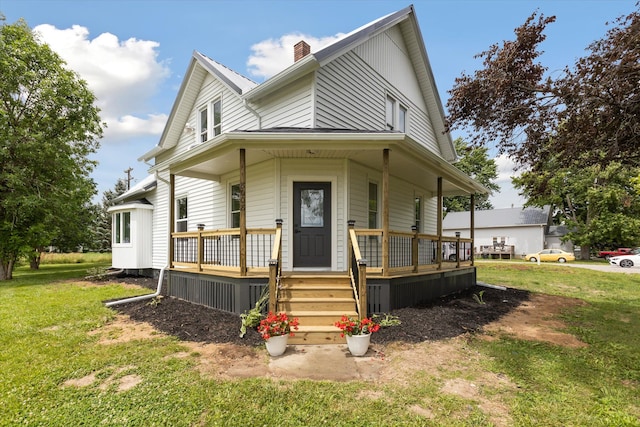 farmhouse inspired home with a chimney, a porch, and a front yard