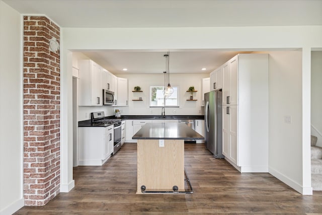kitchen with stainless steel appliances, open shelves, dark countertops, and a sink