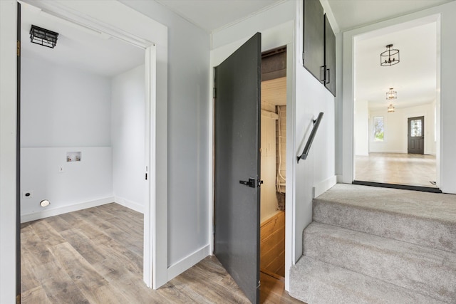 staircase featuring baseboards and wood finished floors