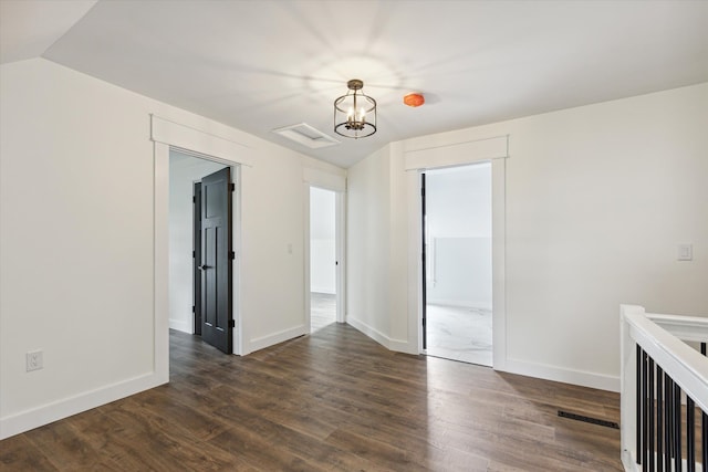 interior space featuring baseboards, visible vents, and dark wood-type flooring