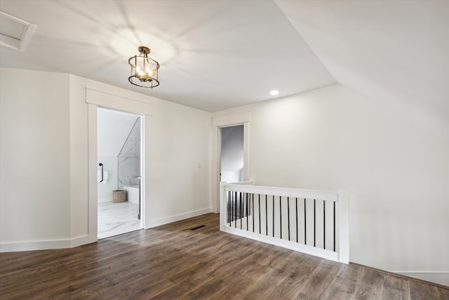 unfurnished room featuring recessed lighting, baseboards, wood finished floors, and vaulted ceiling