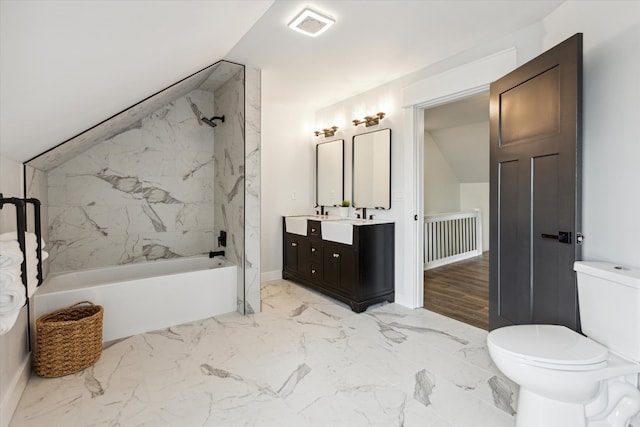 bathroom with vanity, marble finish floor, vaulted ceiling, and toilet