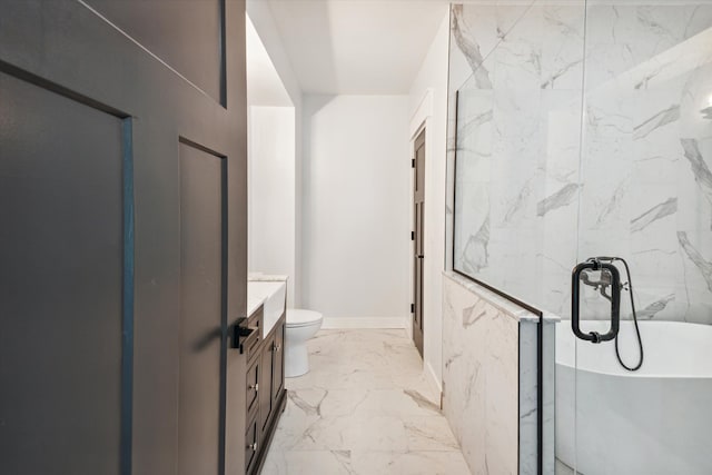 full bathroom featuring toilet, a soaking tub, marble finish floor, and vanity