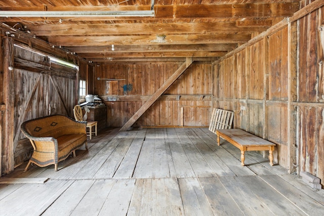 interior space with wood walls and hardwood / wood-style flooring