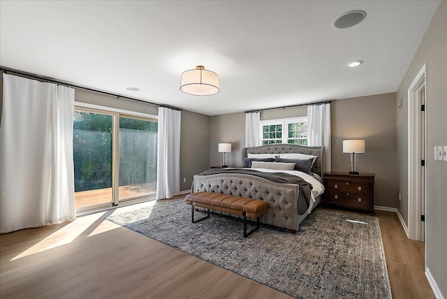 bedroom with access to outside, baseboards, and wood finished floors