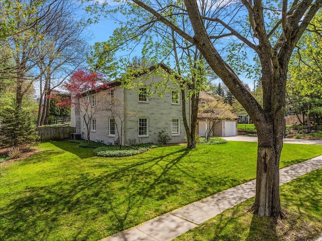 view of side of home with fence, a lawn, driveway, and a garage