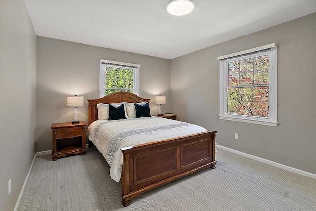 bedroom with baseboards and light carpet