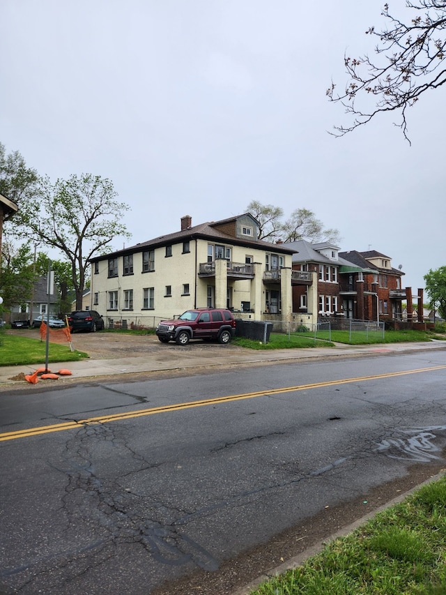 view of building exterior with uncovered parking
