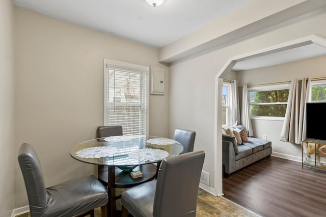 25884 Leach St, Roseville, MI 48066 - dining space featuring arched walkways, baseboards, and wood finished floors