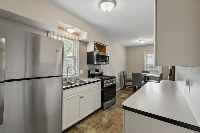 25884 Leach St, Roseville, MI 48066 - kitchen featuring plenty of natural light, a sink, appliances with stainless steel finishes, and white cabinets