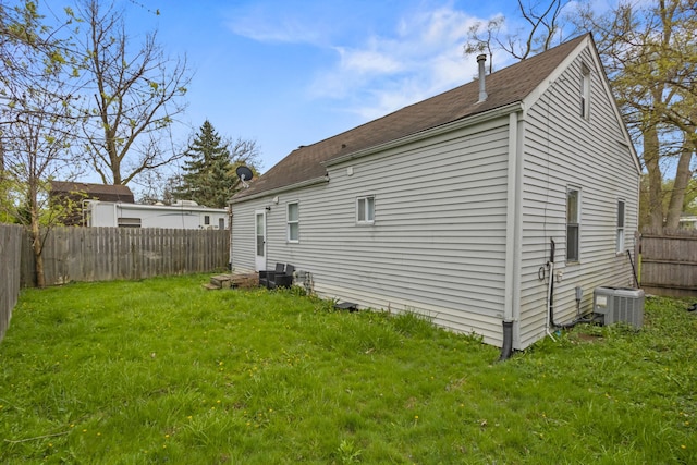 25884 Leach St, Roseville, MI 48066 - view of home's exterior featuring a fenced backyard, roof with shingles, central AC, and a yard