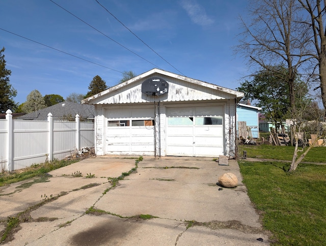 detached garage featuring fence