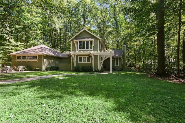 rear view of house with a lawn, a pergola, and a chimney