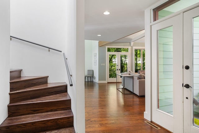 staircase featuring french doors, recessed lighting, baseboards, wood finished floors, and visible vents