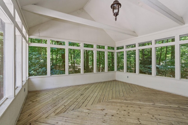 unfurnished sunroom with vaulted ceiling and a deck