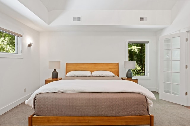 carpeted bedroom featuring baseboards and visible vents