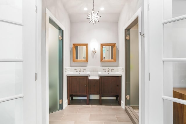 bathroom with double vanity, a sink, tile patterned floors, and recessed lighting