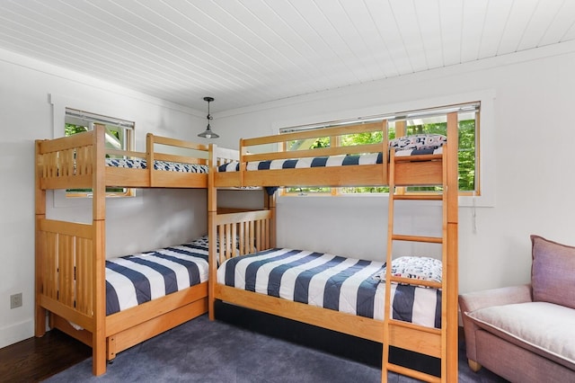 bedroom with wood finished floors, multiple windows, and wooden ceiling