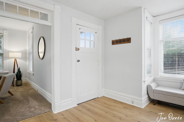 entryway featuring light wood-style floors and baseboards