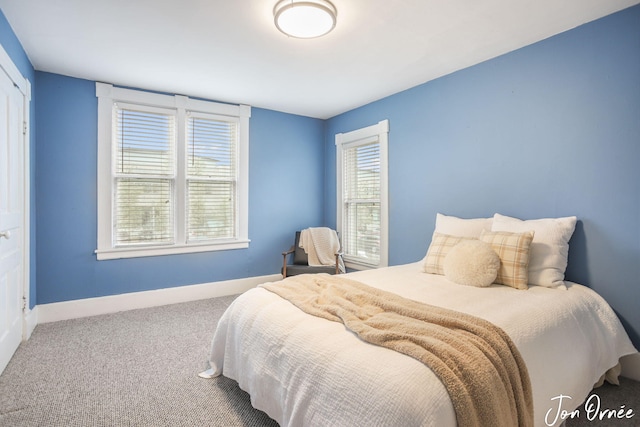 carpeted bedroom featuring baseboards