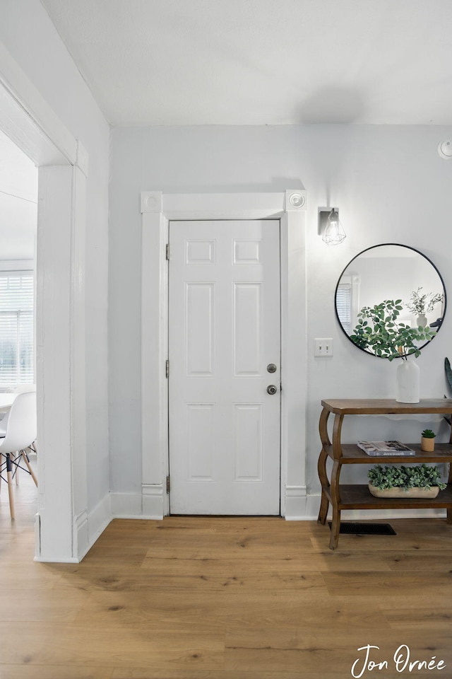 entrance foyer featuring light wood-type flooring and baseboards