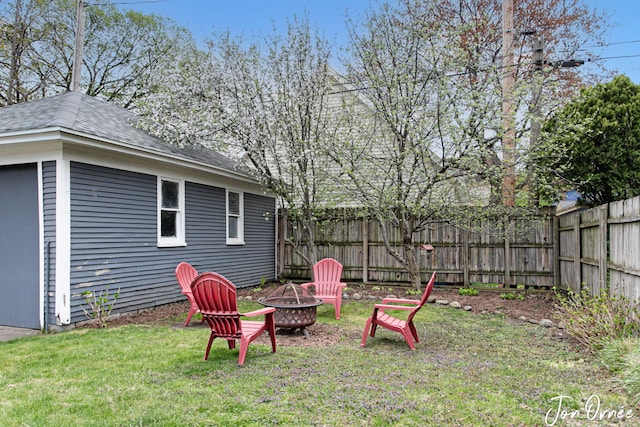 view of yard with a fire pit and a fenced backyard