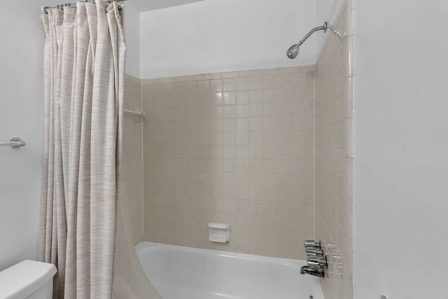 full bath featuring toilet and shower / tub combo with curtain
