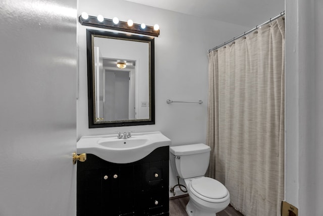 bathroom with vanity, toilet, and wood finished floors