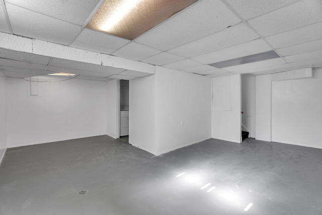 finished below grade area with baseboards and a drop ceiling