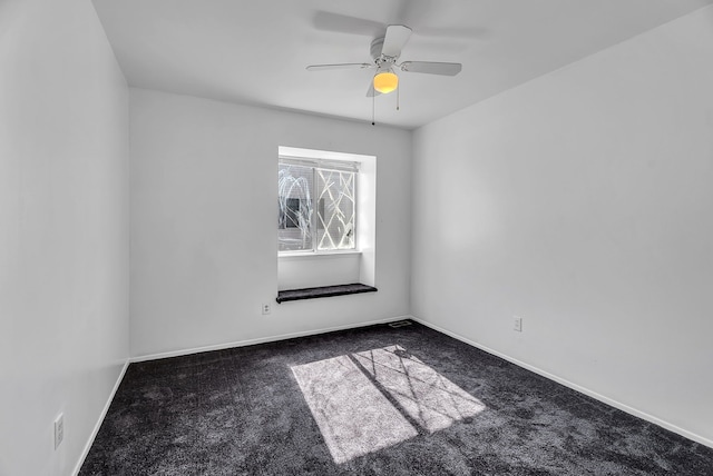 carpeted empty room featuring baseboards and a ceiling fan