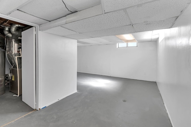 basement with a paneled ceiling