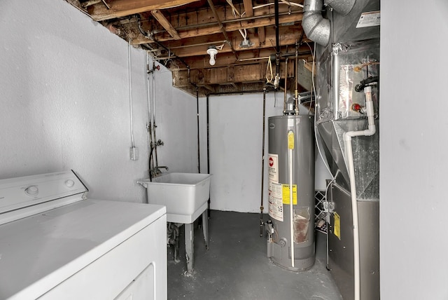 unfinished below grade area featuring washer / clothes dryer, a sink, and gas water heater