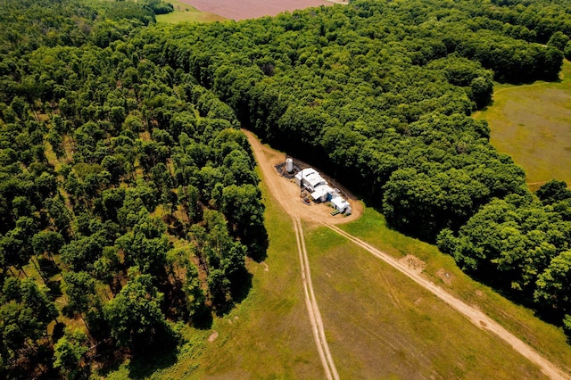 birds eye view of property with a view of trees