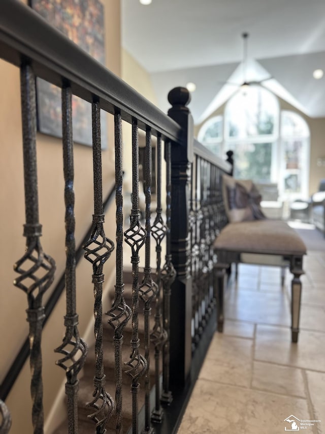 stairway featuring recessed lighting, vaulted ceiling, and stone tile flooring