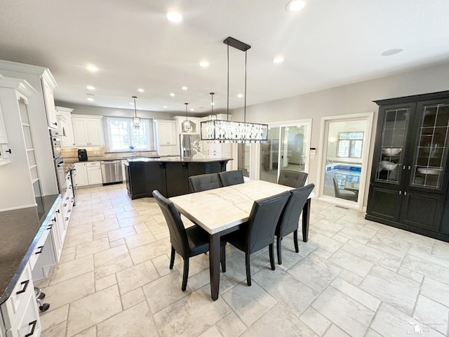 dining area featuring stone tile floors and recessed lighting